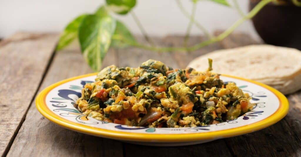 veggie and egg free scramble in colorful bowl on wooden counter