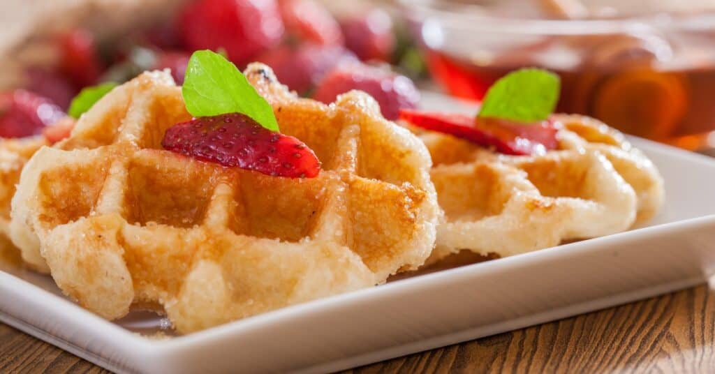 plate with Belgian waffles with berries on top