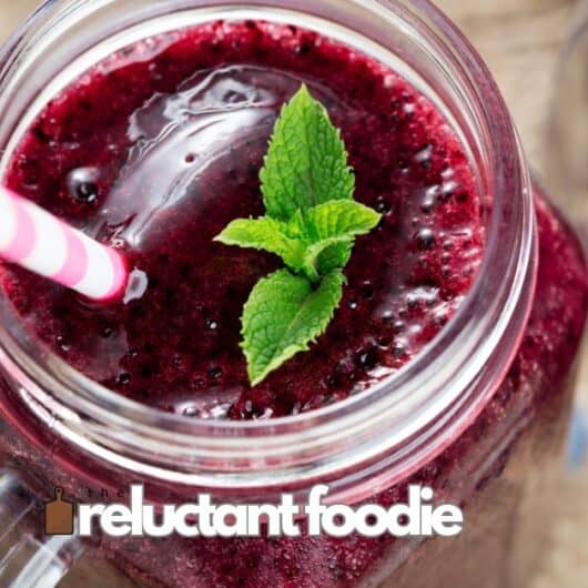 berry smoothie in mason jar with straw