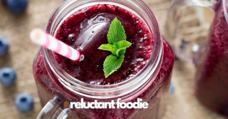 berry smoothie in mason jar with straw