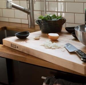 boos maplewood cutting board on counter prepping veggies on it