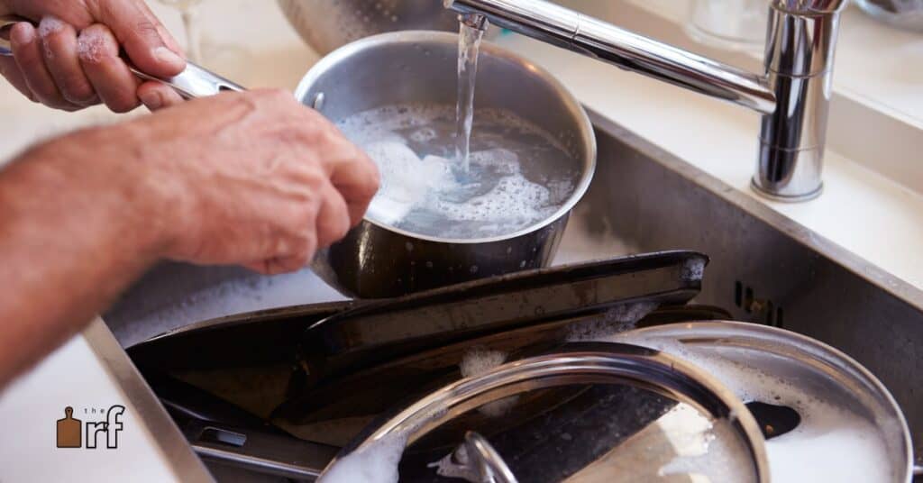 cleaning pans in sink