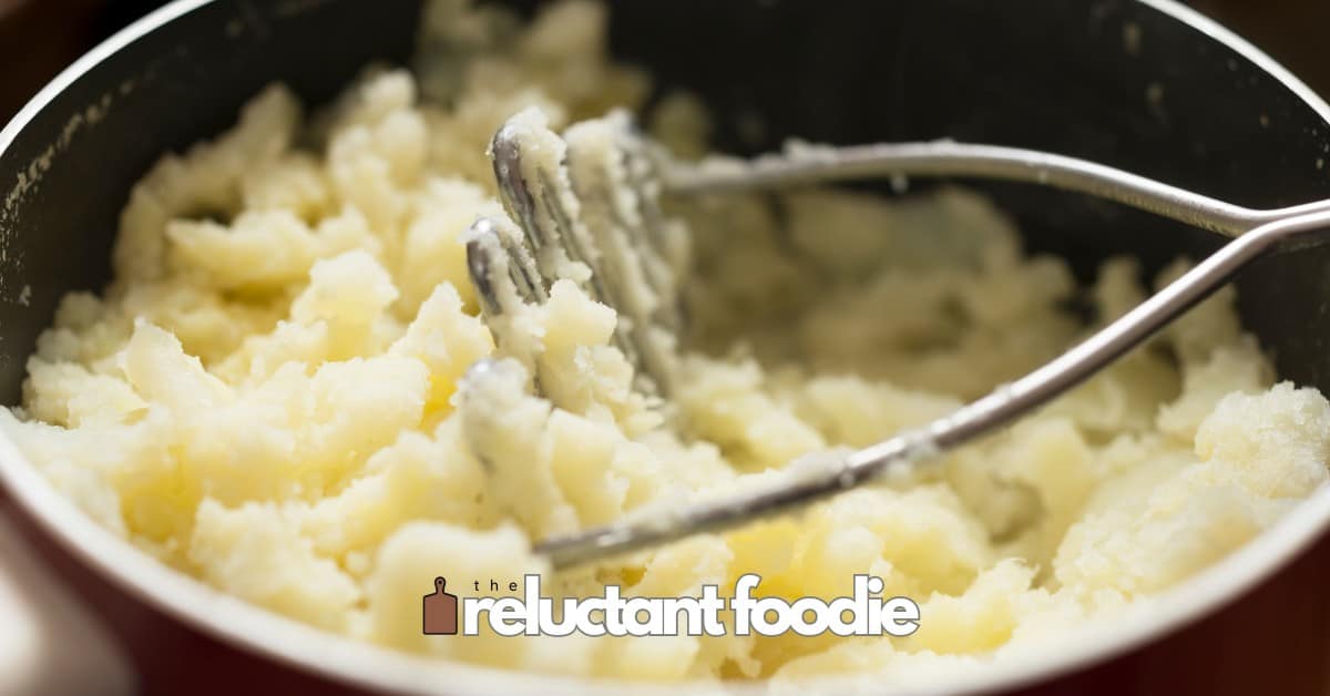 dairy free garlic mashed potatoes with potato masher