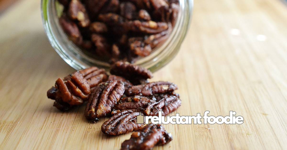 spiced pecans in jar spilled onto counter