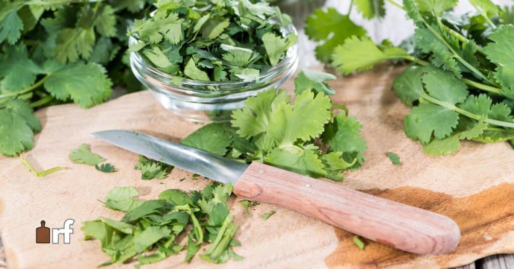 chopped cilantro on cutting board with knife